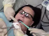 Dental nurse assists with minor oral surgery