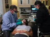 Dental nurse assists with root canal therapy